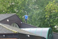 Man risks falling from roof