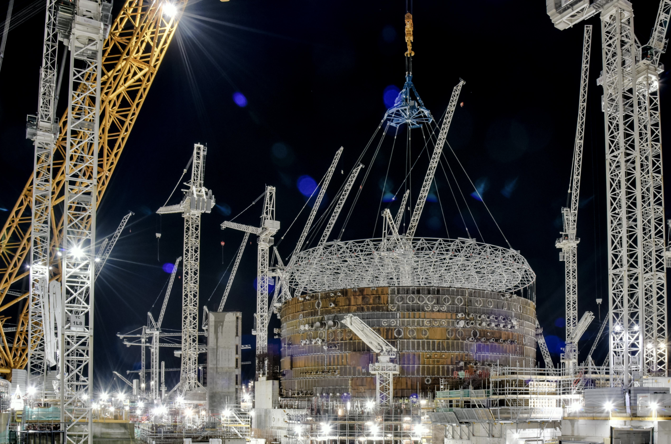 The liner ring and steel containment for each reactor, being lifted in