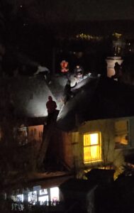 Roofer working by phone light